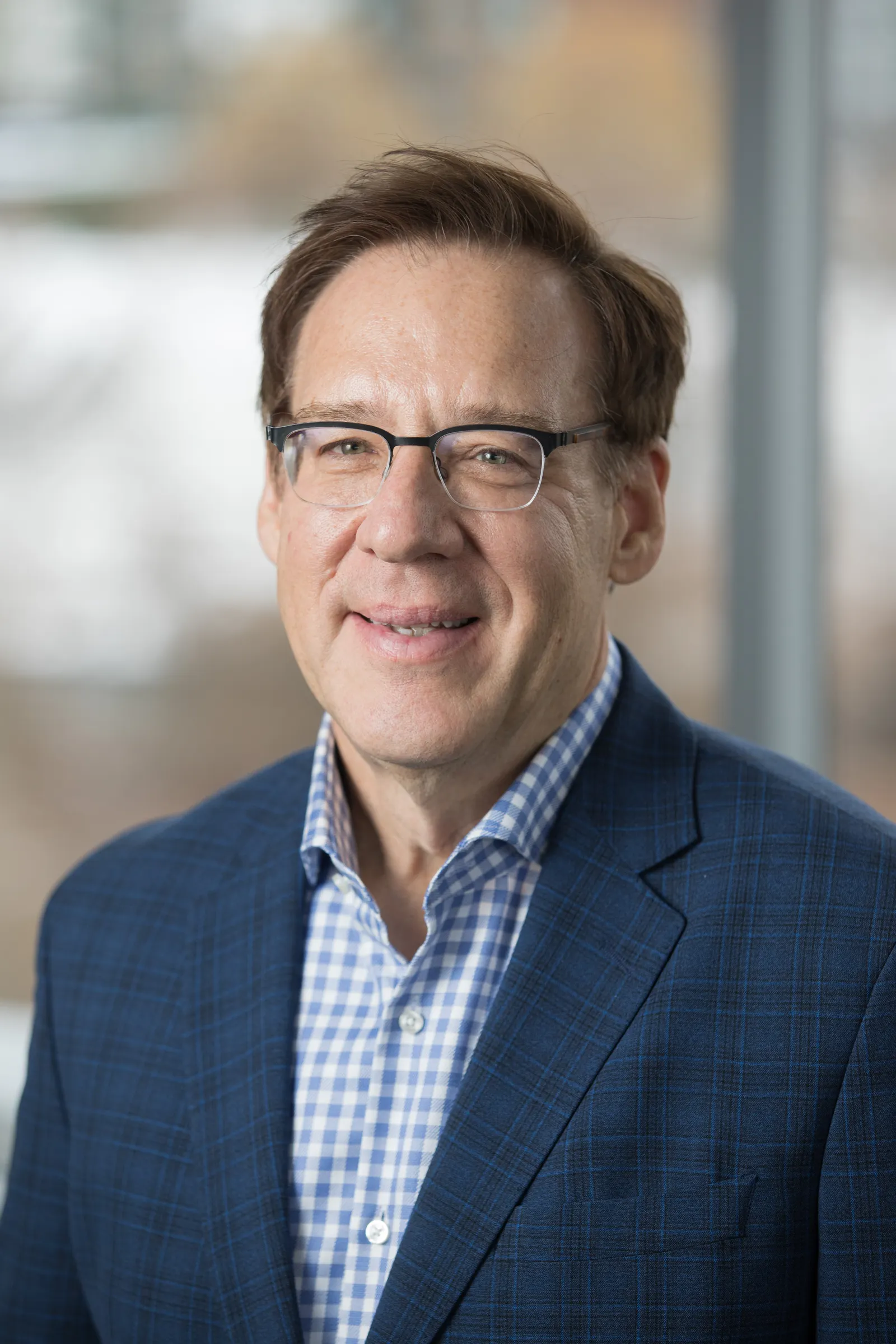 A man smiles into the camera in this headshot