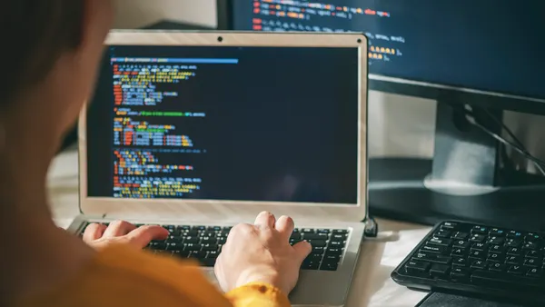 Programmer coding on laptop