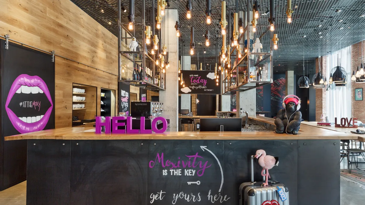 A hotel bar with pink and black accents.