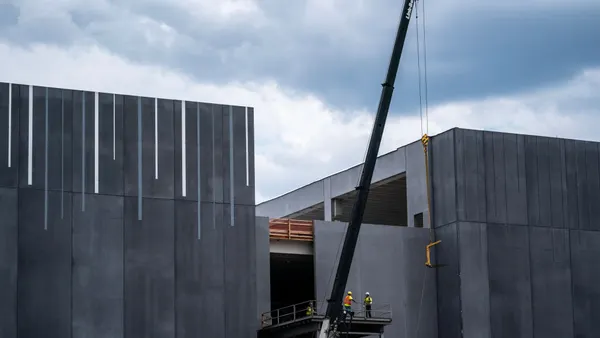 A construction crew with a crane raises materials into place to construct a data center in Virginia in July 2024.