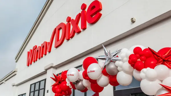 Exterior of Winn-Dixie grocery store on opening day with balloon arch