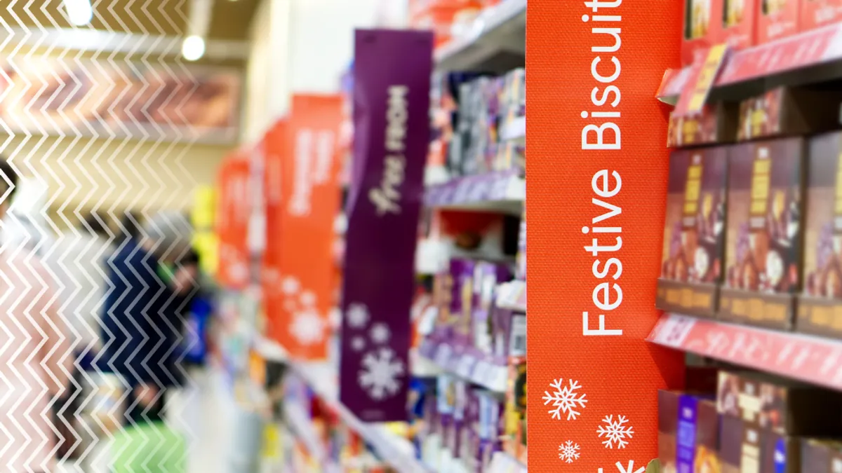 Aisle with holiday-themed signage in a supermarket.