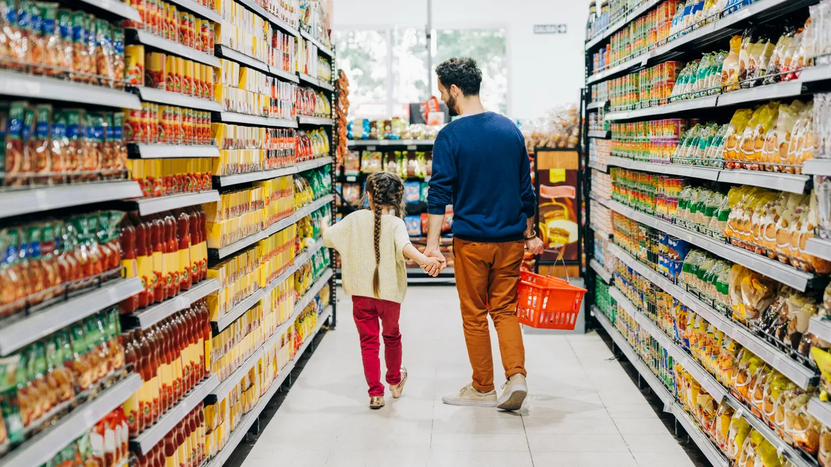 Father and daughter shopping at grocery store.