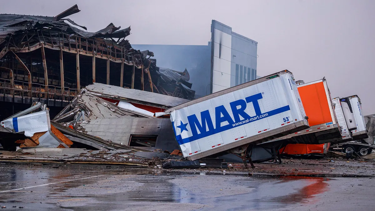 Burnt docking ports and cargo trucks at a fulfillment center.