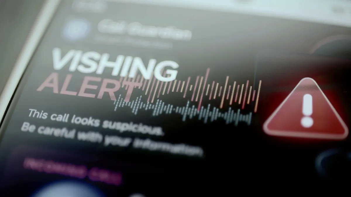 A close-up image of a vishing alert on a mobile phone warning that an incoming call looks suspicious and to be careful with personal information.