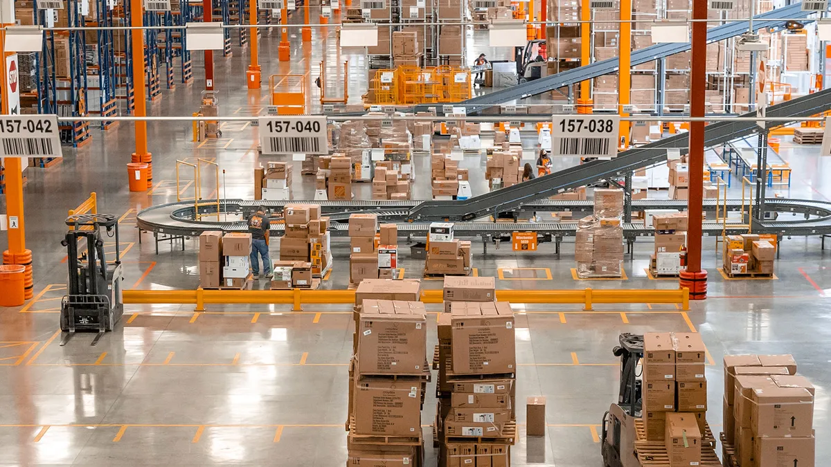 Aerial view indoors of a warehouse space with Home Depot boxes on pallets