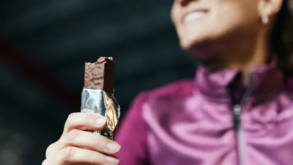 woman eats protein bar