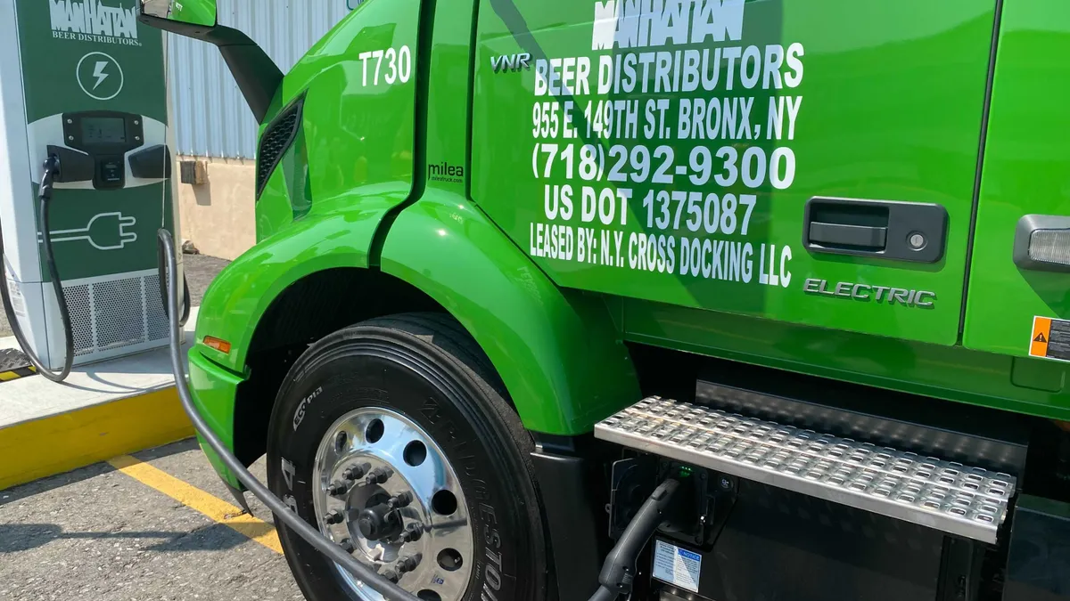 Green truck getting fuel