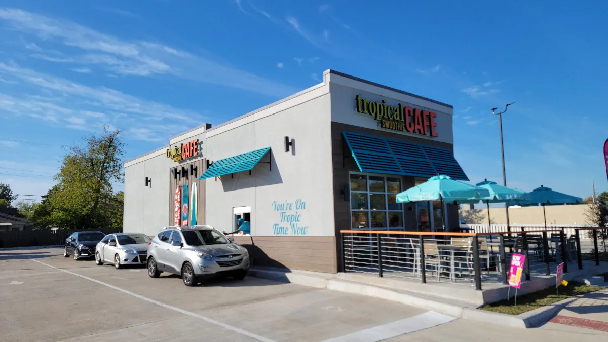 A picture of a beige building with Tropical Smoothie Cafe branding