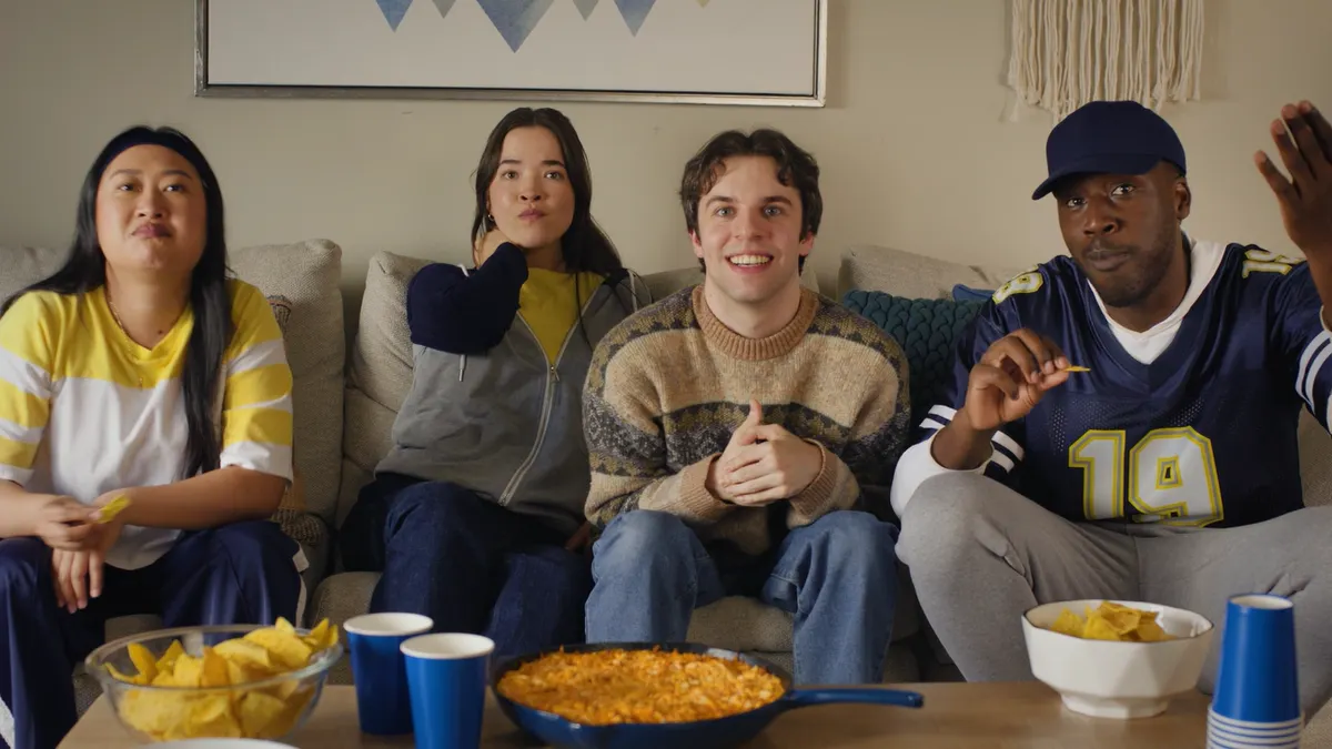 A group of people watch a football game in a Hellmann's ad