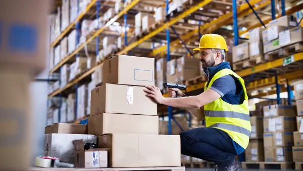 Worker in a warehouse dealing with boxes