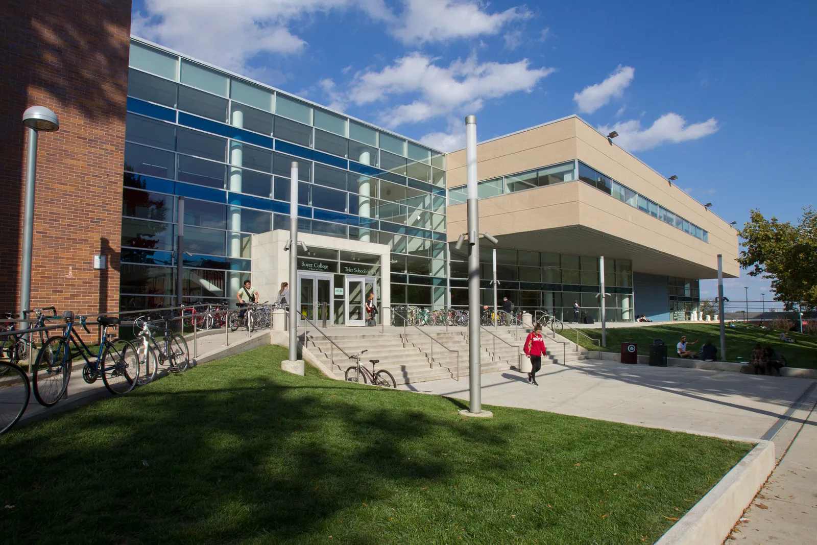 Glass front with annex in view. Students filter in and out of the front doors.