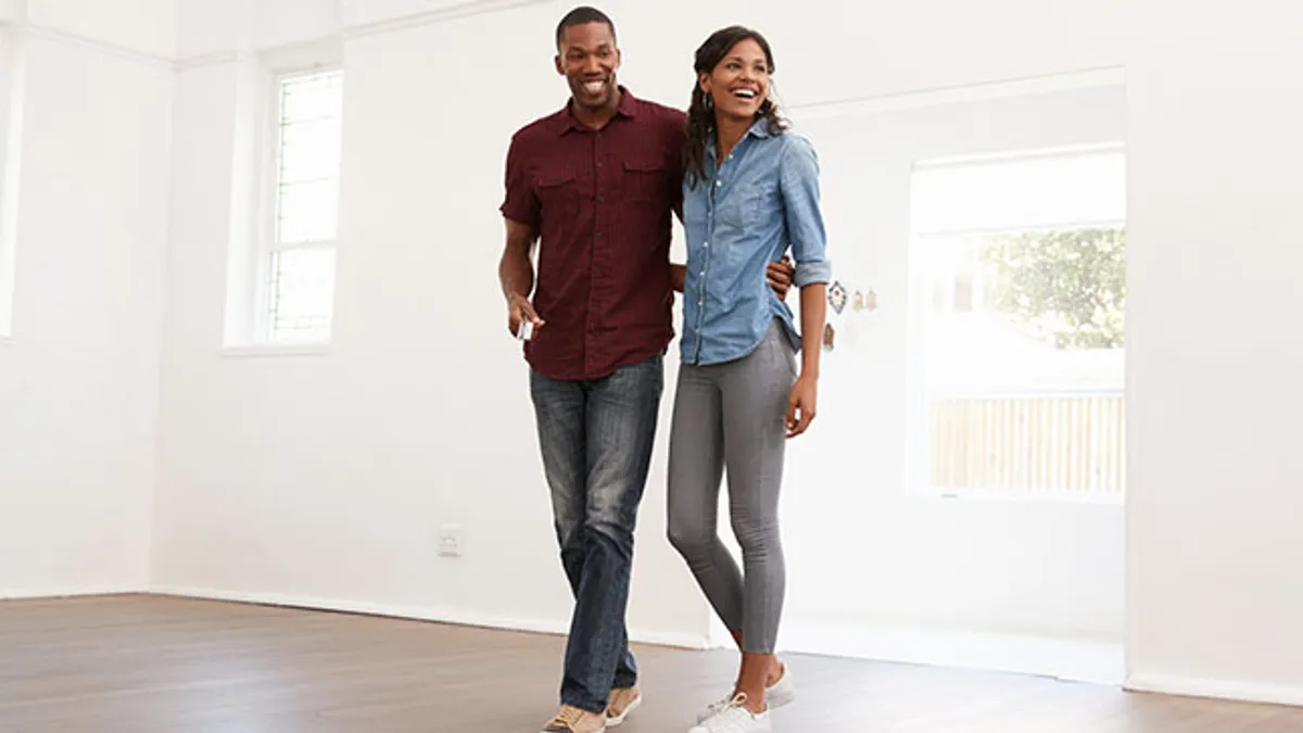 Excited young couple moving into new home together