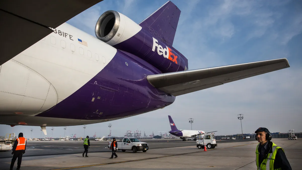 Workers prepare to offload an incoming FedEx plane at a FedEx global hub, one of only seven in the U.S., on December 16, 2014 in Newark, New Jersey.