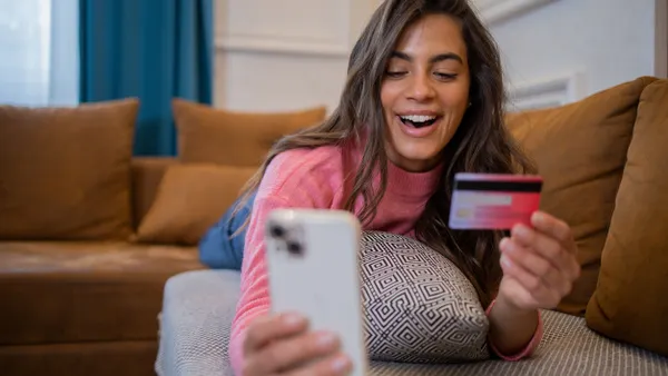 Person entering card number into phone