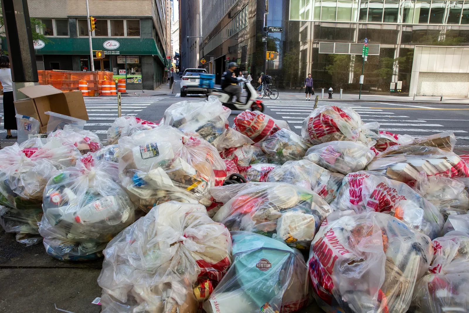 Pile of clear plastic bags full of waste/recycling on a street in New York