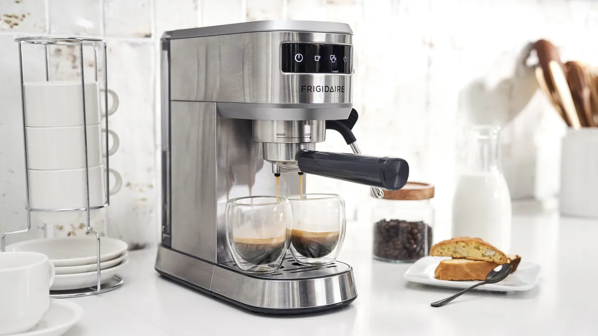 A Frigidaire espresso maker brewing espresso