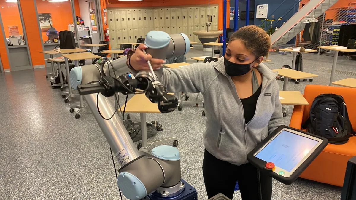 Aliyna Willis, a senior at Butler Tech in southwest Ohio, works on equipment in the Mechatronics lab.