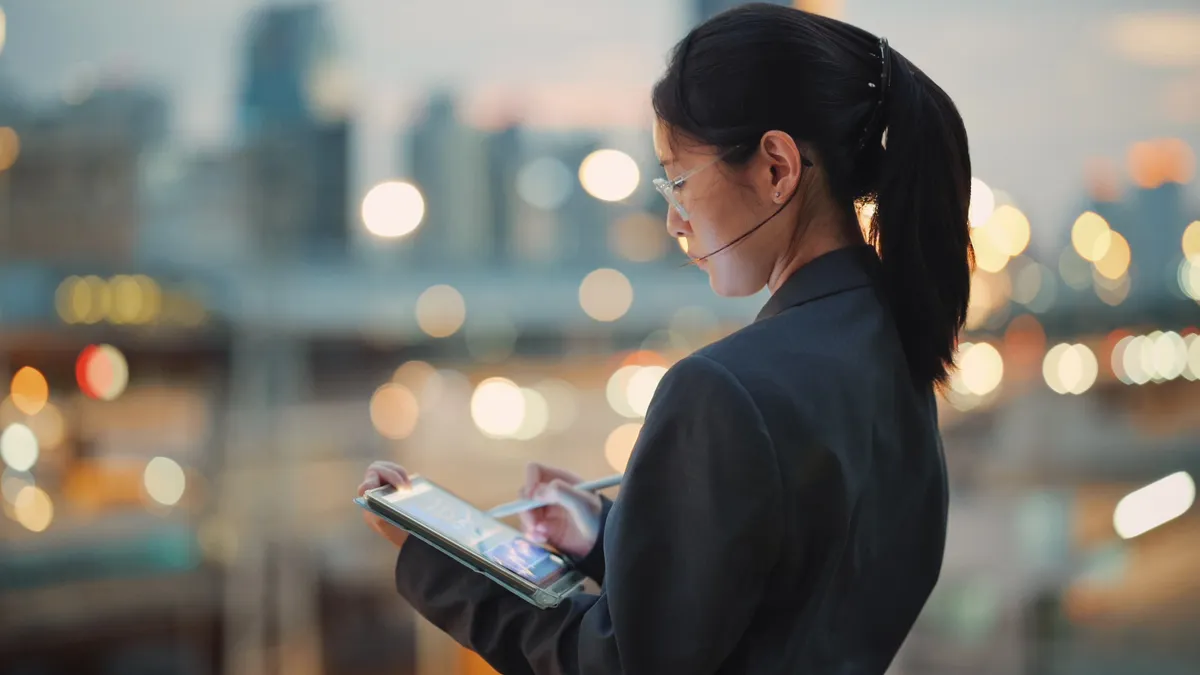 Global investor coding business AI tools on a digital tablet showcasing the creation of software solutions for enterprisesuse of AI in business.