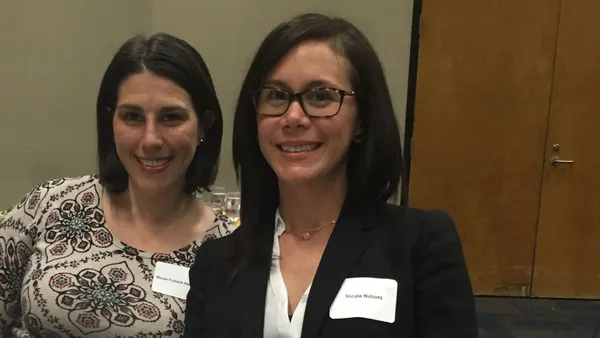 Two women sit at a table.