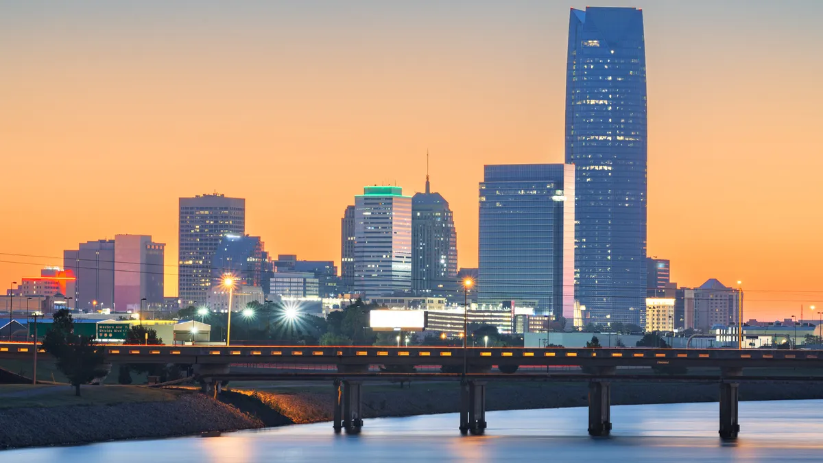 Oklahoma City, Oklahoma, downtown skyline on the Oklahoma River at dawn.