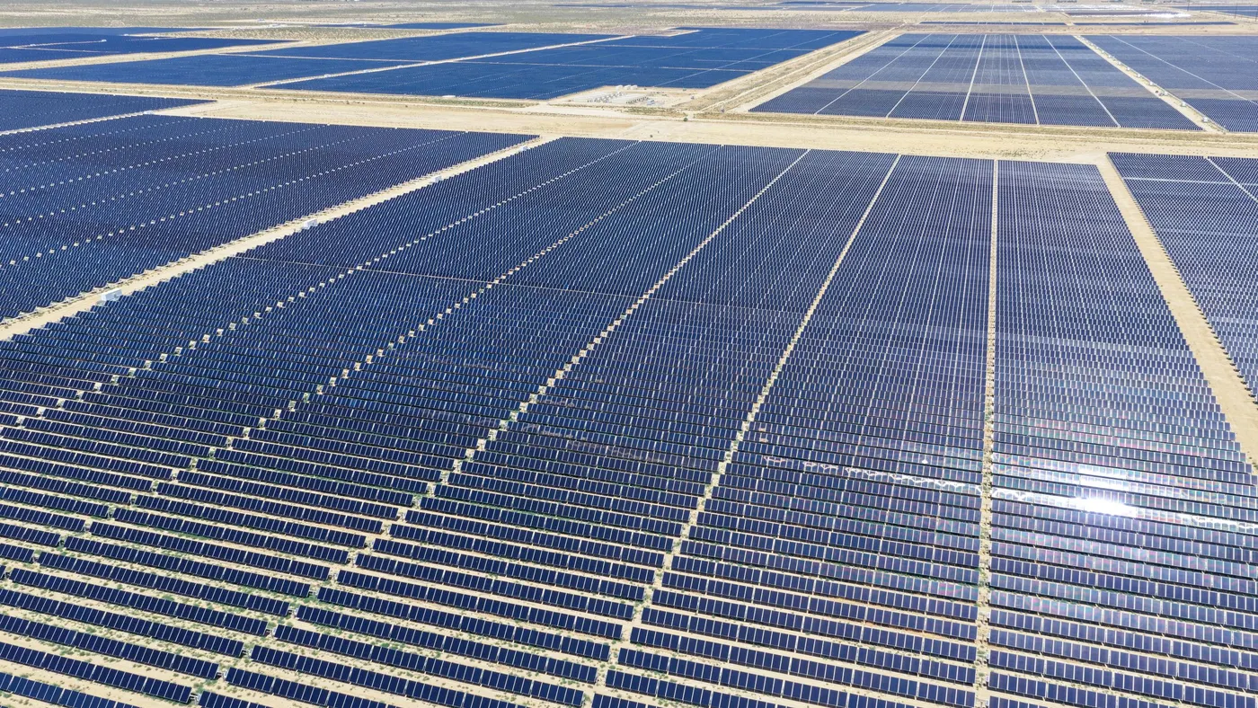 A large solar panel array in a desert landscape