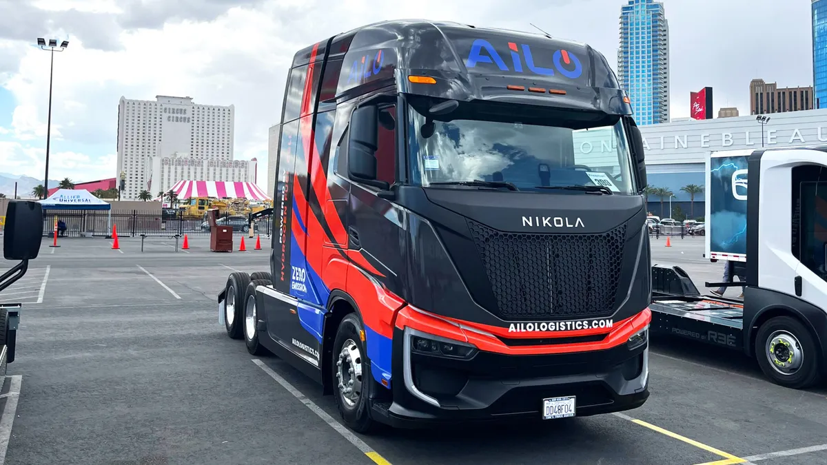 An AiLogistics-branded Nikola fuel cell electric truck without a trailer is parked on a lot in Las Vegas.