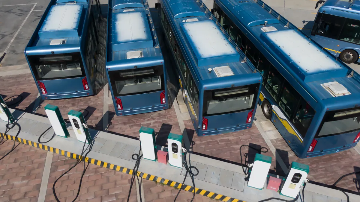 Aerial shot of electric buses parked near chargers