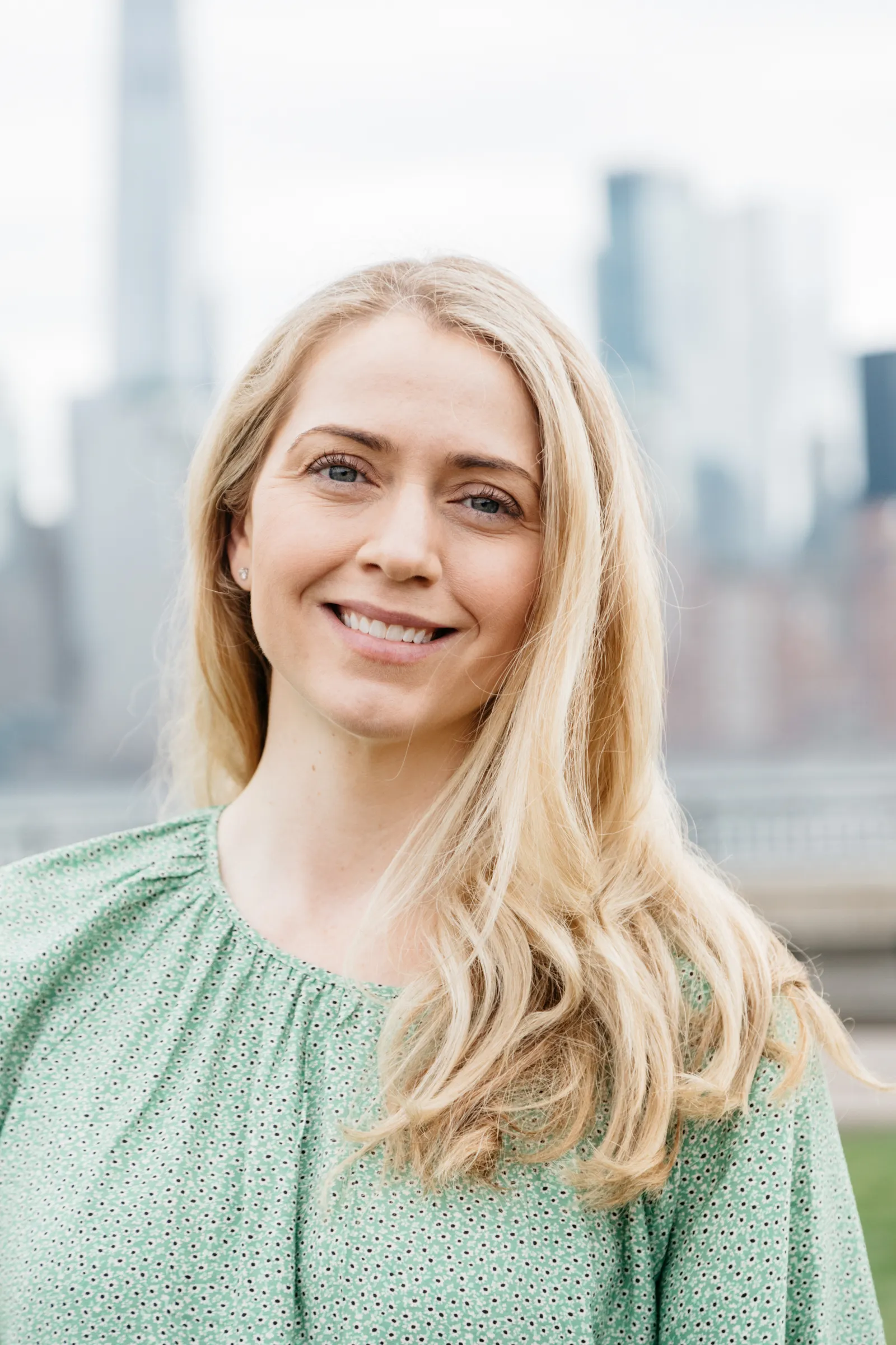 Headshot of Diane Lewis, who had long blonde hair and a light blue shirt