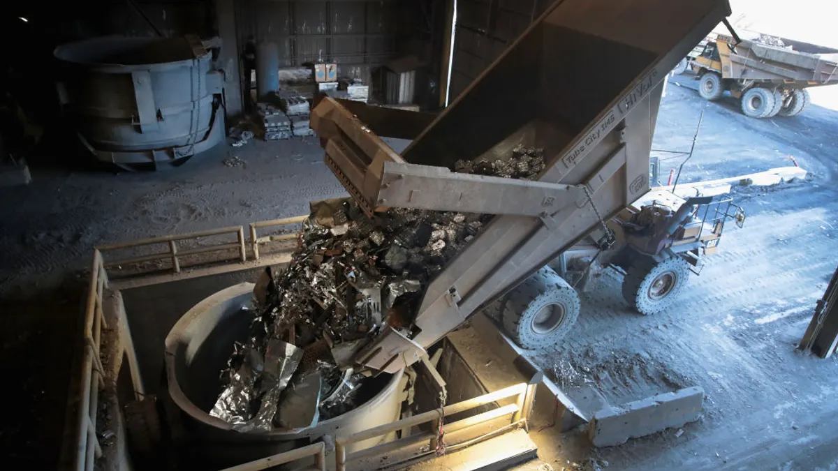 Scrap steel seen being loaded into a bucket.