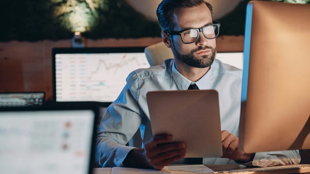 Confident young man working on computer