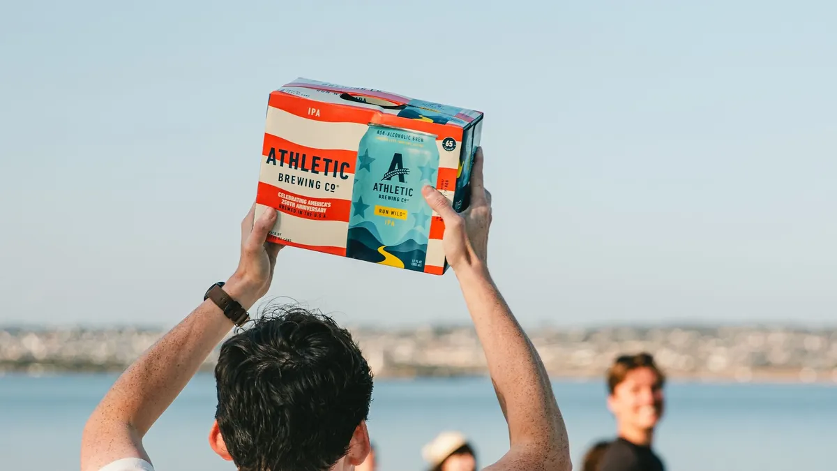 Man holds case of Athletic