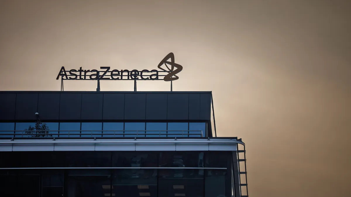 An AstraZeneca logo stands atop an office building.