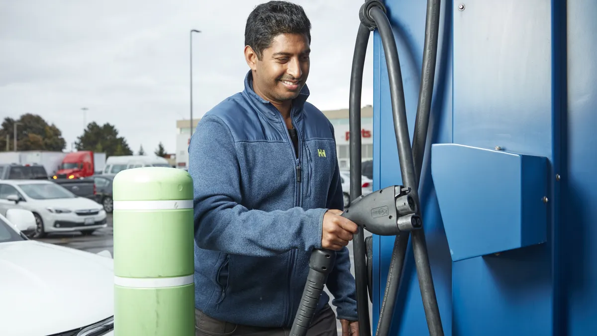 Man using EV charging machinery