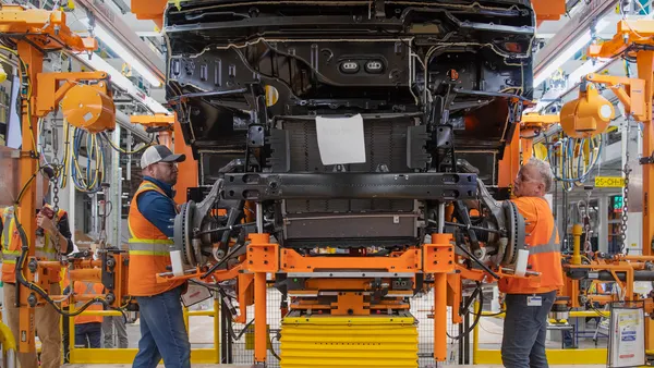Two employees work on the production line at General Motors' CAMI Assembly plant in Ingersoll, Ontario.