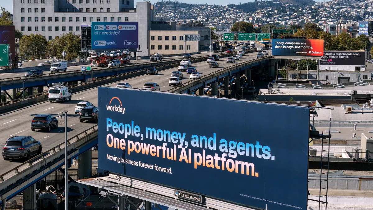 A Workday billboard says "People, money and agents. One powerful AI platform. Moving business forever forward."