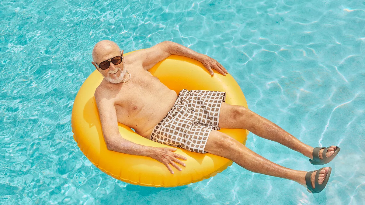 A person wearing the Bombas Friday Slides in a pool