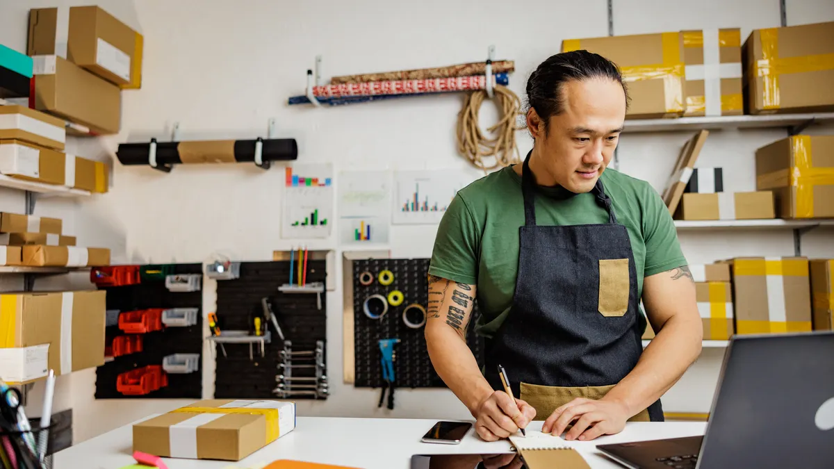Asian man working in retail in online store