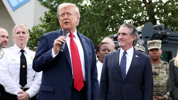 President Donald Trump visits the U.S. Park Police Anacostia Operations Facility on August 21, 2025 in Washington, DC. Interior Secretary Doug Burgum looks on.