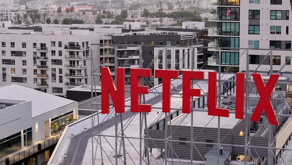 In an aerial view, the Netflix logo is displayed above Netflix corporate offices.