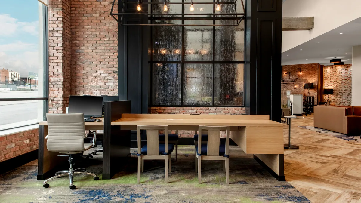 A table with desks in a hotel lobby.
