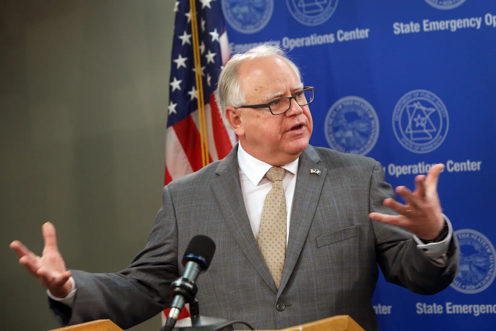 Tim Walz speaks at a podium