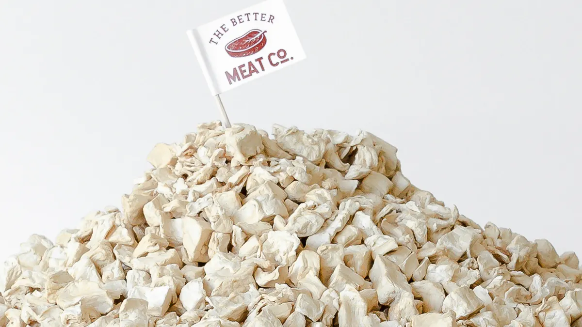 A mount of Better Meat Co's mycelium Rhiza protein, which is in a solid form of white chunks, with a company toothpick flag on top.