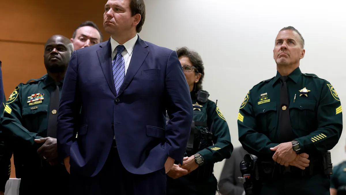 Florida Gov. Ron DeSantis stands in front of police officers.