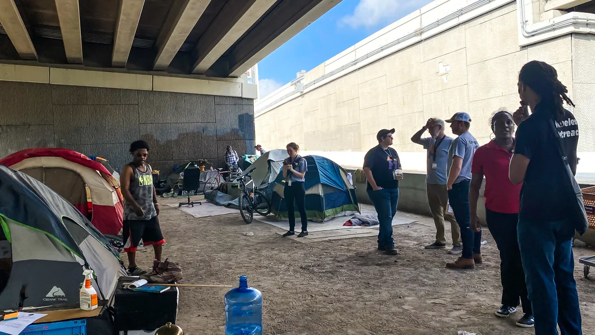 Homeless outreach coordinators at an encampment in Houston.