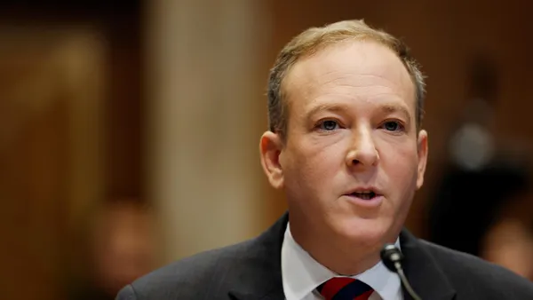 Lee Zeldin sits at a desk