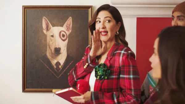 Actor D'Arcy Carden speaks to a group alongside a painted portrait of Target mascot Bullseye in a holiday ad from the retailer.