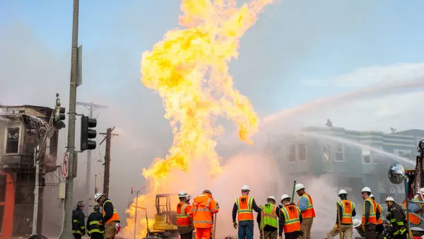 Gas explosion in San Francisco with water hoses putting it out and people in neon vests