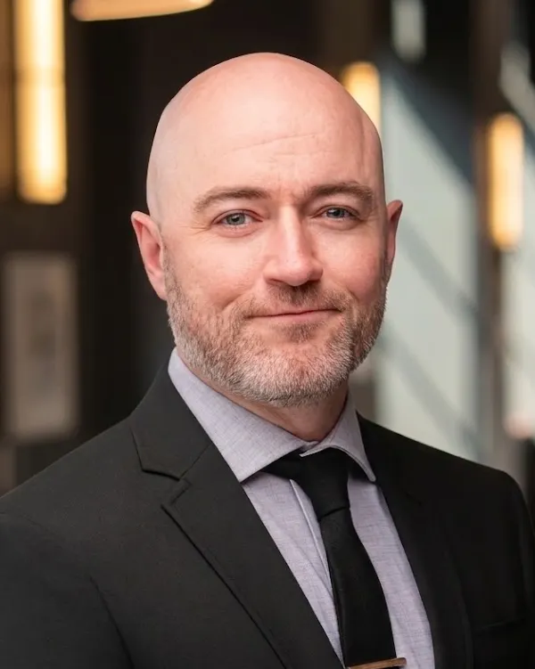 Headshot of a man in a suit.