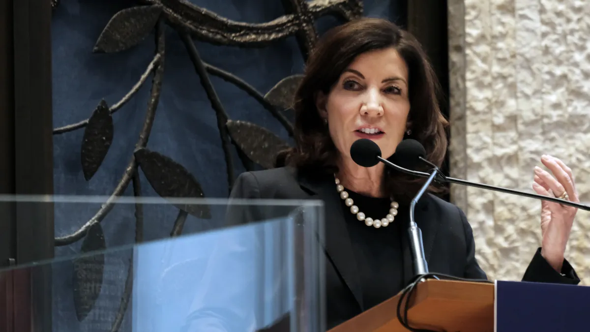 New York Gov. Kathy Hochul speaks at a podium.